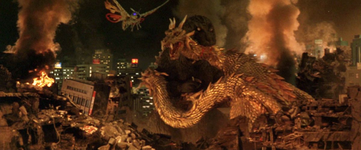 Godzilla biting the neck of King Ghidorah with a ruined city in the background and Mothra flying towards them.