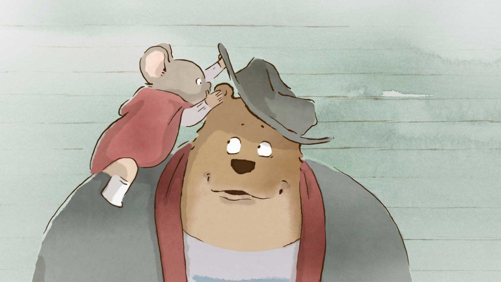 An adorable mouse whispers in an adorable bear’s ear after lifting up the bear’s hat in Ernest &amp; Celestine.