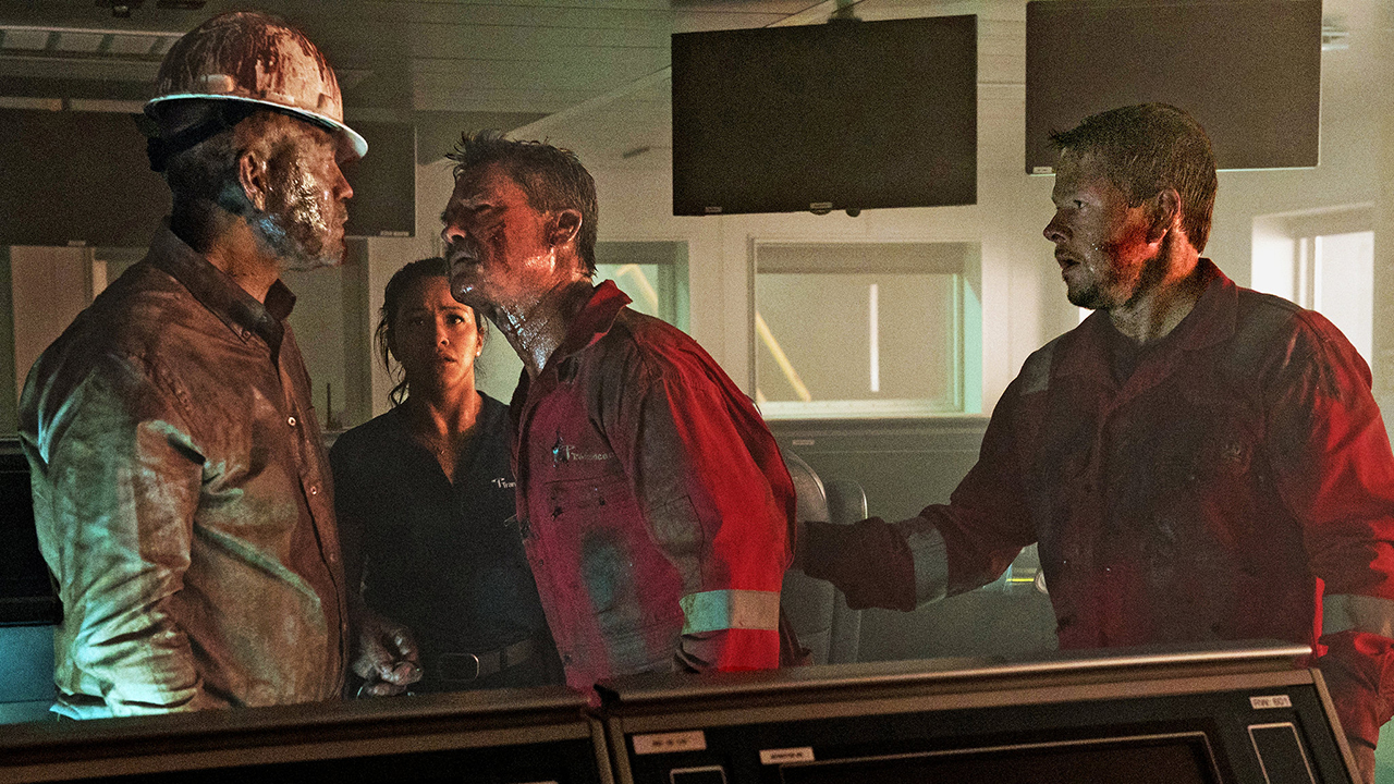 Three men and one woman look worried on a boat in this still from the movie Deepwater Horizon