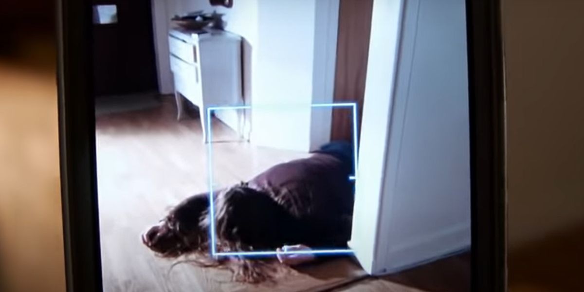 A woman's body on the ground through the camera of a phone.