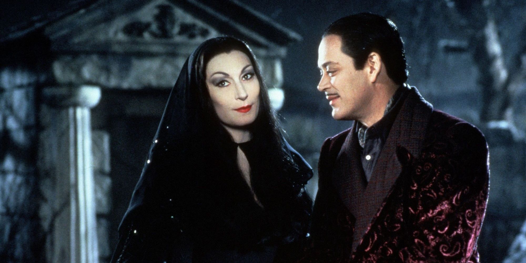 Raúl Juliá looks lovingly at Anjelica Huston in The Addams Family